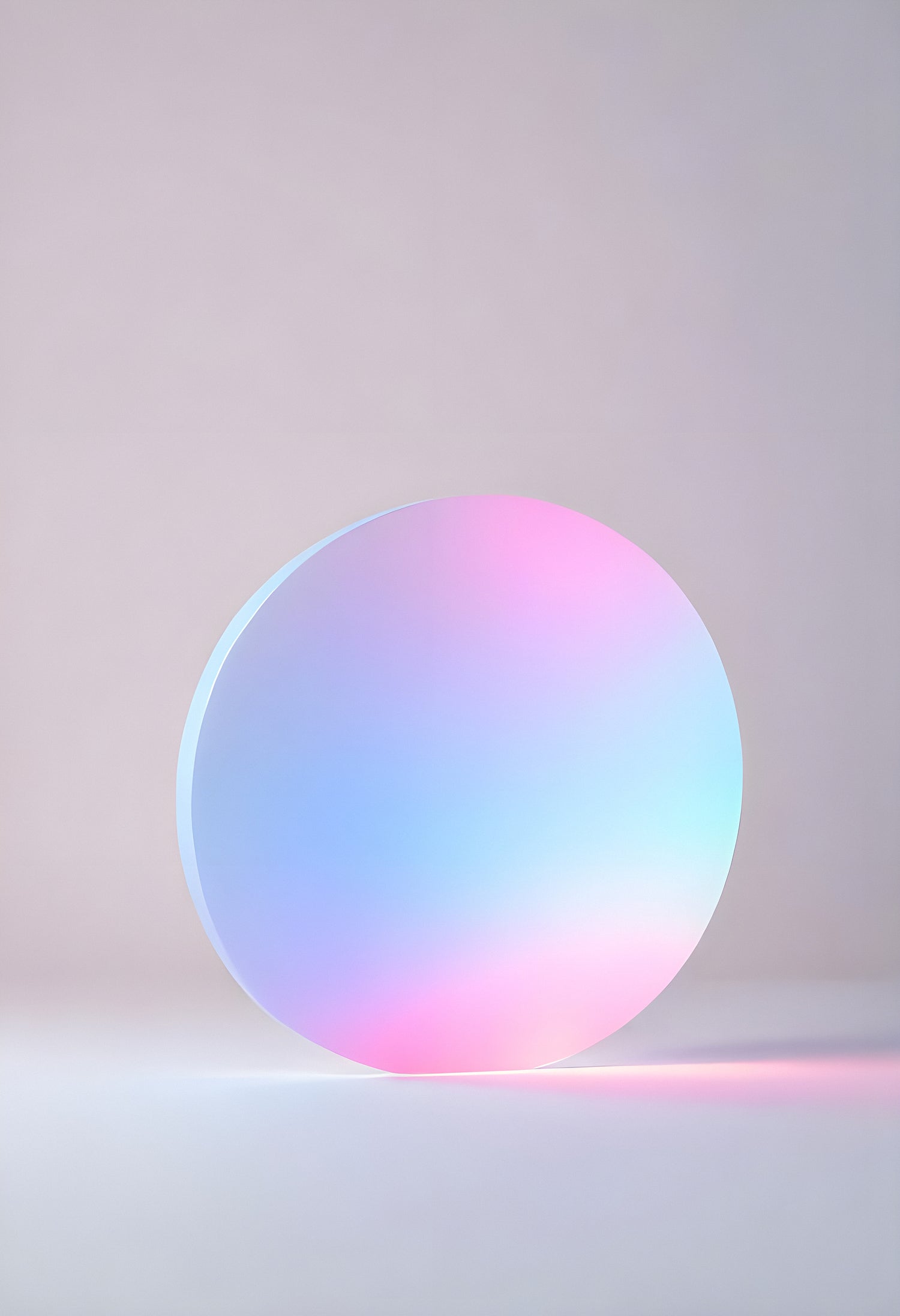 Glowing circular object casting soft pastel colors against a minimalist backdrop in a softly lit studio environment