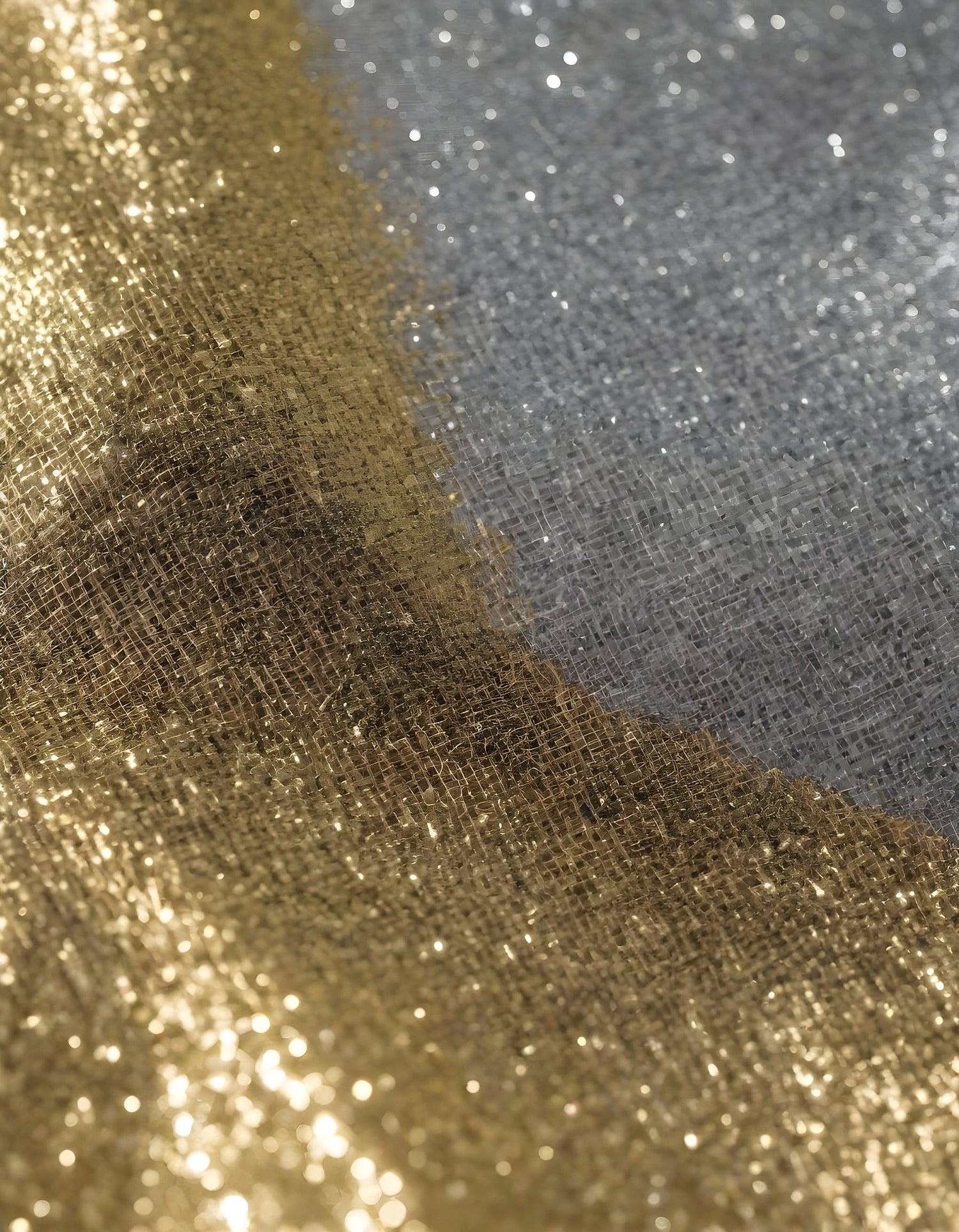 Shimmering gold and silver fabrics layered together in a luxurious arrangement during daylight