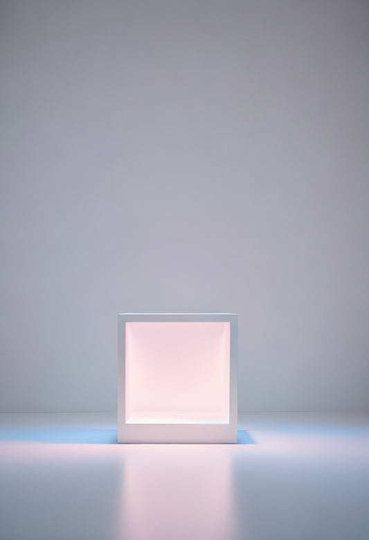 A minimalistic white cube illuminated from within, creating a calming ambiance against a simple gray background