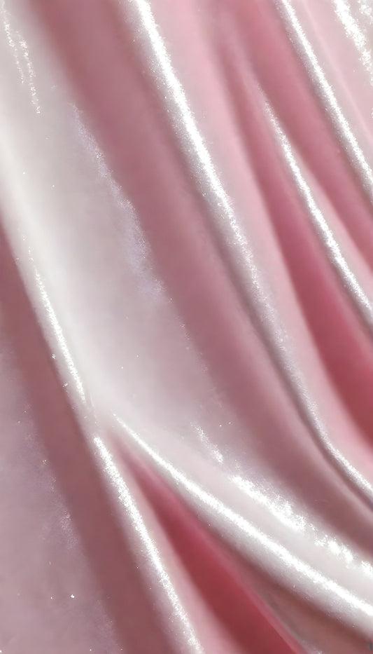 A close-up view of soft, shiny pink fabric draped elegantly, highlighting its smooth texture and sheen, perfect for luxurious designs