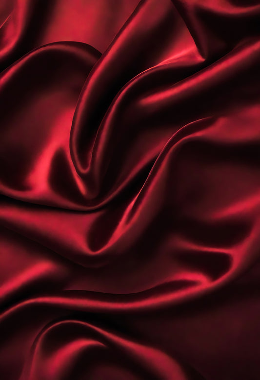 Rich red satin fabric draped elegantly on a surface