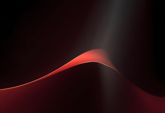 Elegant red wave gracefully undulating against a dark backdrop, showcasing the interplay of light and shadow