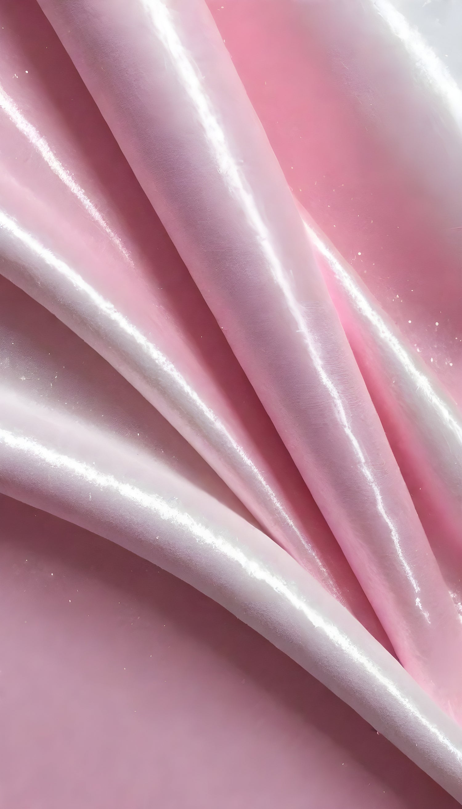 A close-up view of soft, shiny pink fabric draped elegantly, highlighting its smooth texture and sheen, perfect for luxurious designs