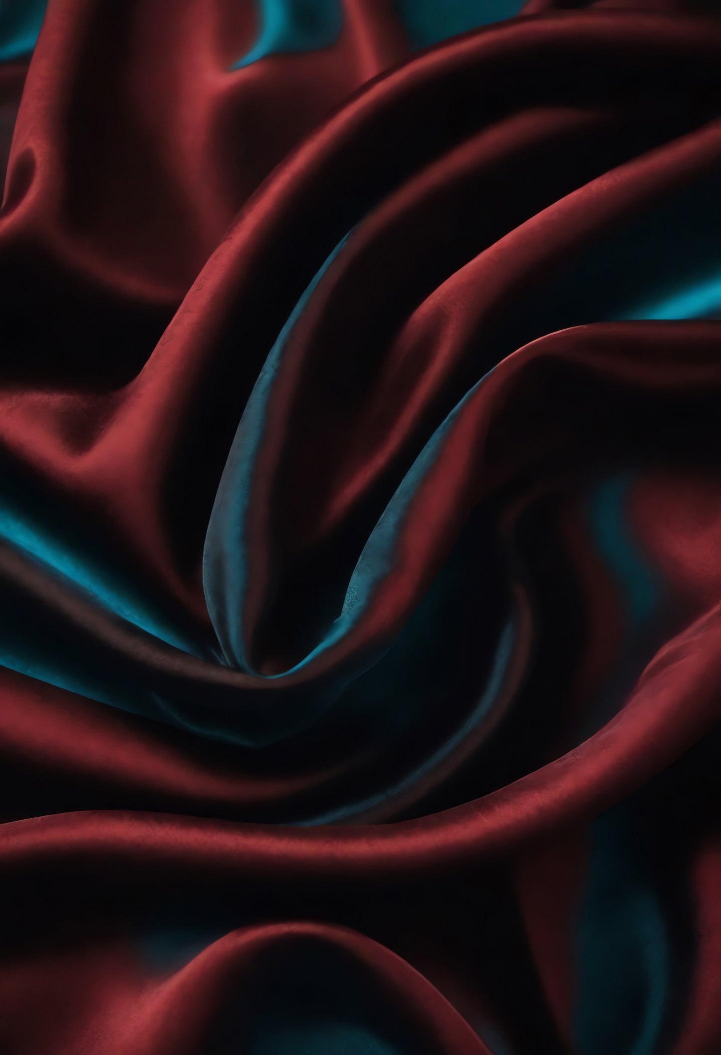 Sleek red and blue satin fabric elegantly draped to create a luxurious texture and depth in a dimly lit setting