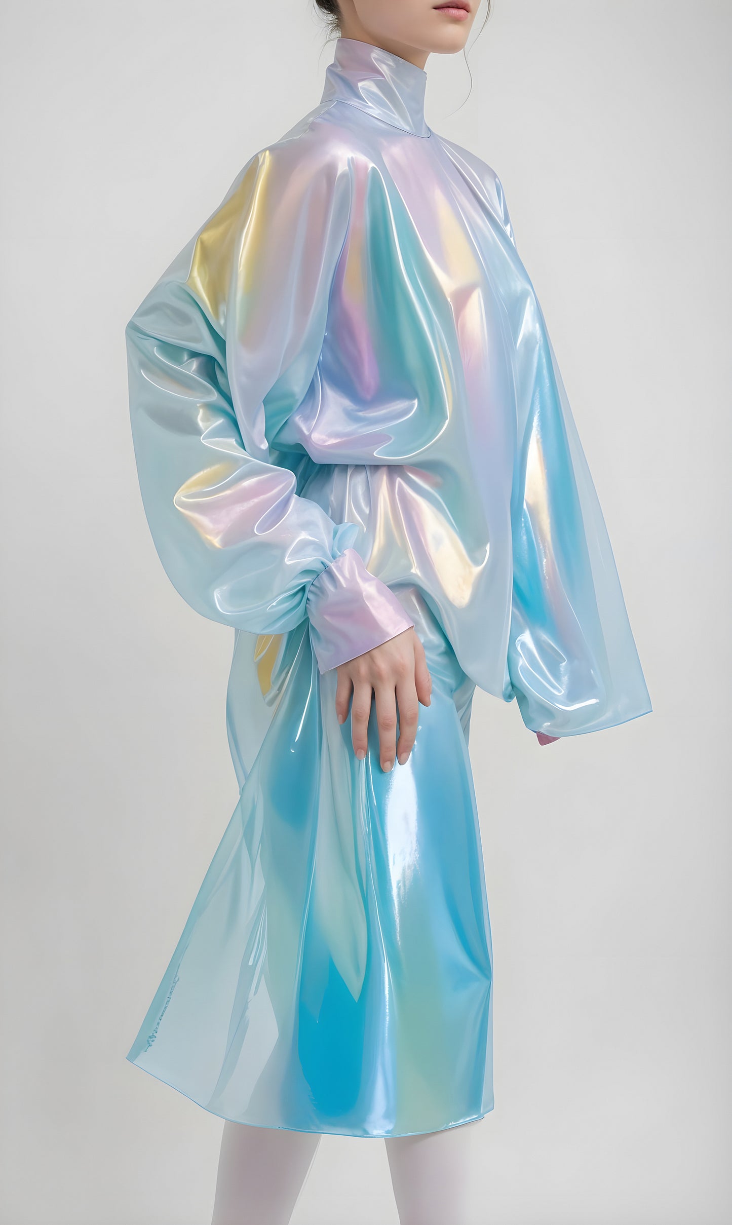 A model showcases a shimmering iridescent outfit in a minimalist indoor setting, emphasizing modern fashion trends