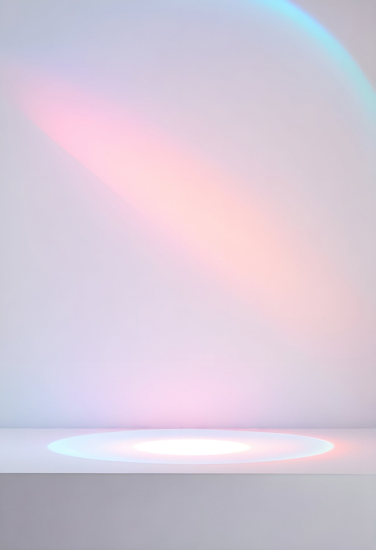 Soft pastel light reflecting off a simple white surface with a subtle rainbow effect in a calm, minimal indoor setting