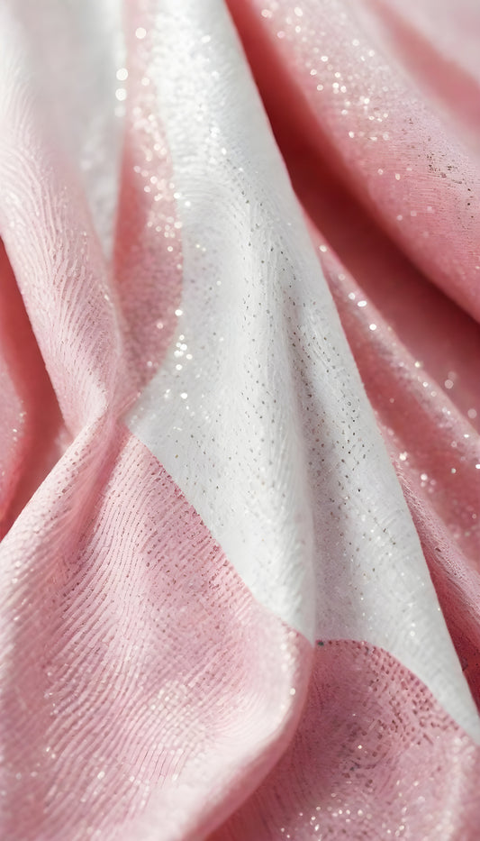 A close-up view of soft, shiny pink fabric draped elegantly, highlighting its smooth texture and sheen, perfect for luxurious designs