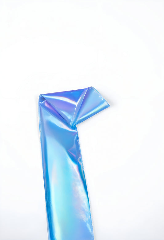 A shiny blue iridescent ribbon folded elegantly on a white background showcasing its vibrant colors and smooth texture