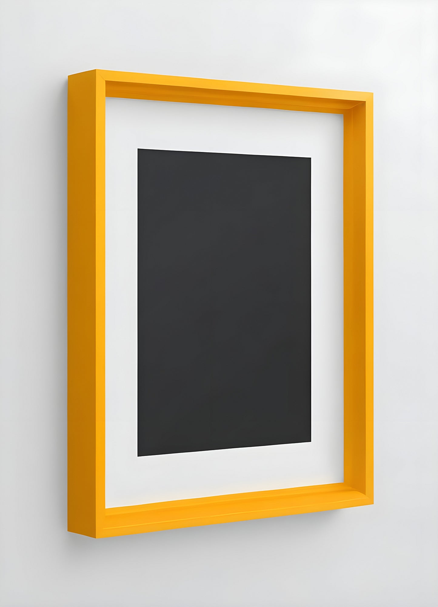 A bright yellow frame showcasing an empty black canvas on a white wall in a modern interior space