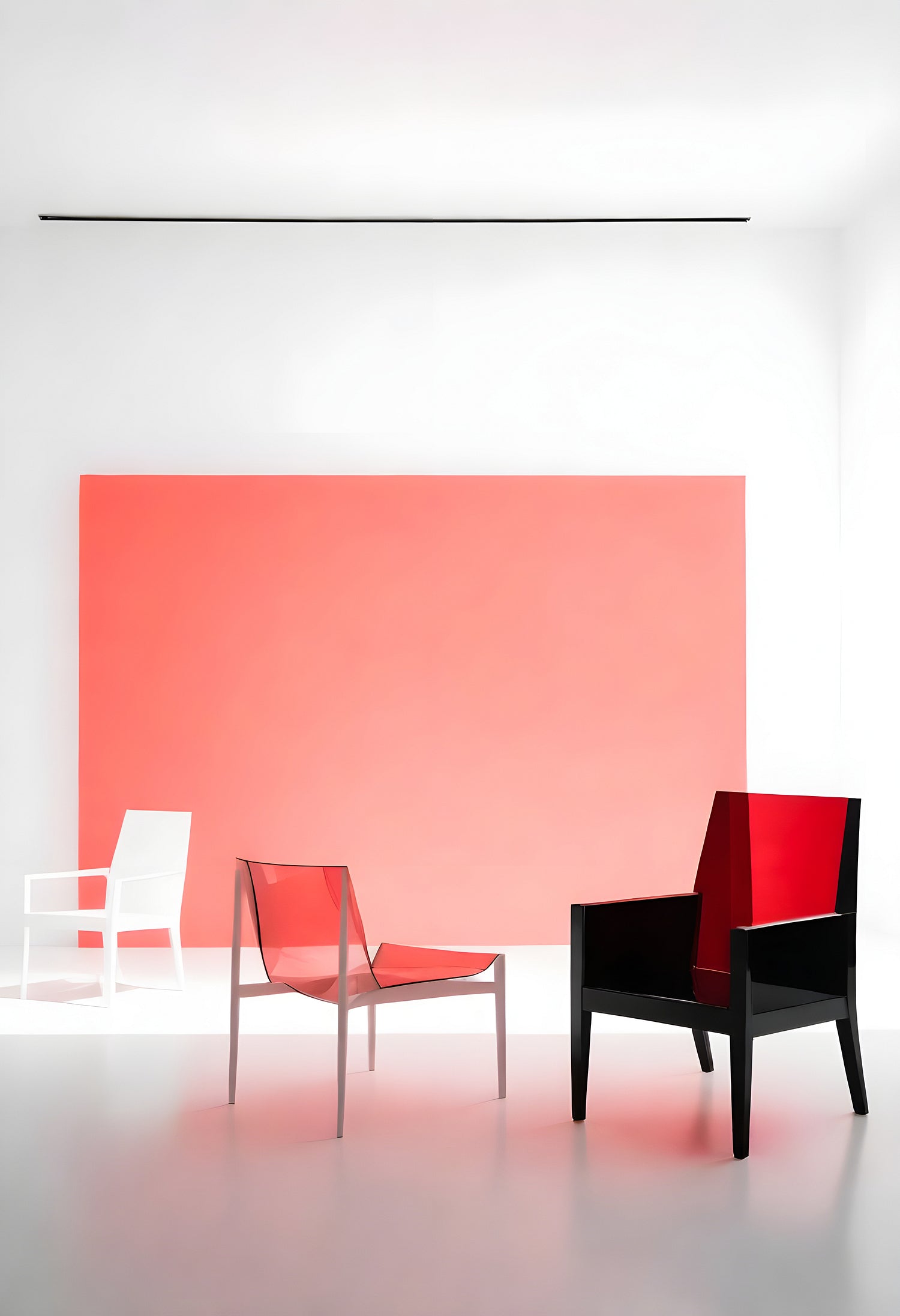 Modern chairs in a minimalist interior with a bold coral wall and bright lighting creating a serene atmosphere