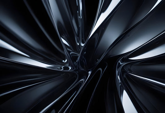 Abstract close-up of smooth black curves creating a dynamic pattern in a reflective surface