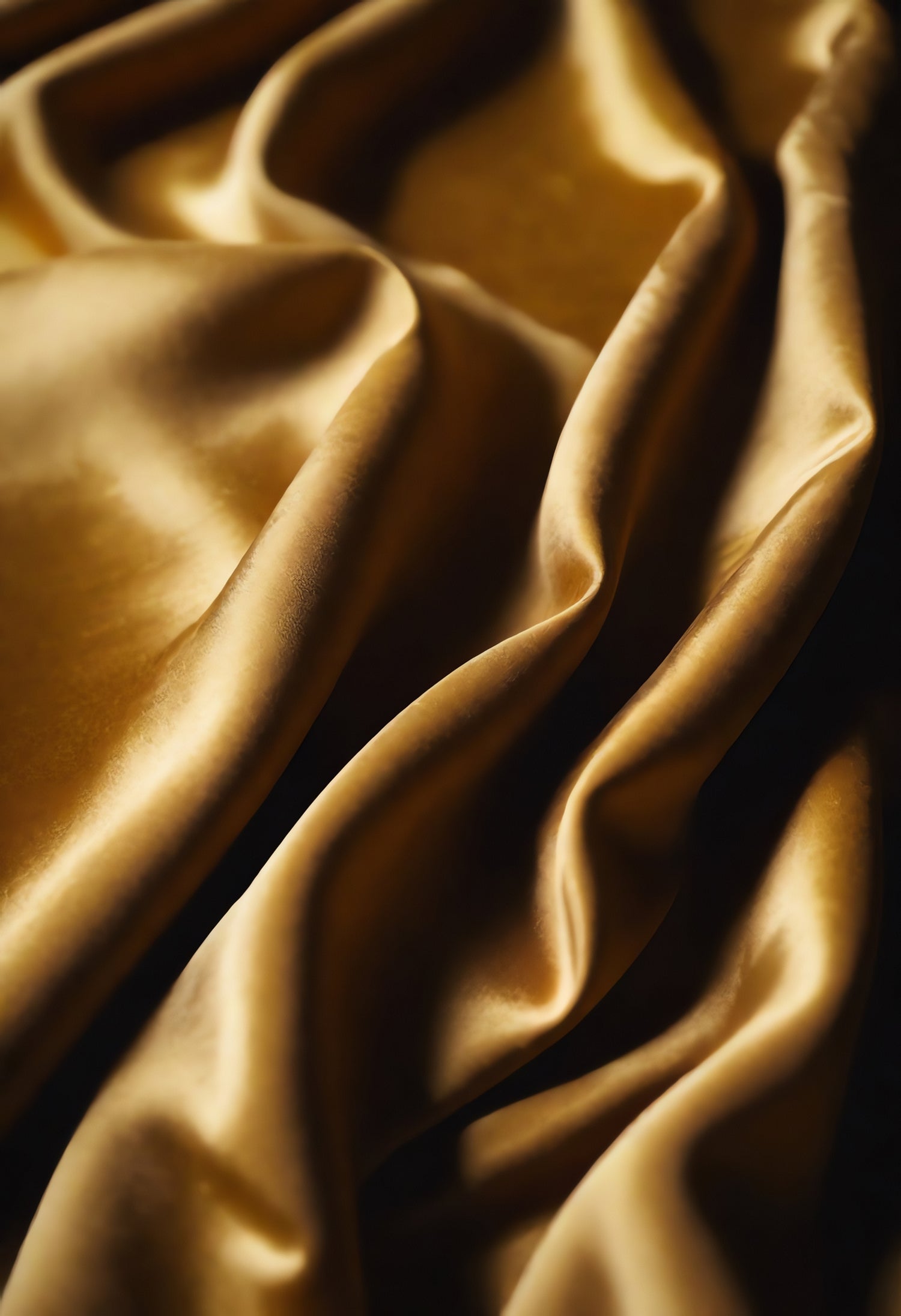 Elegant gold satin fabric draping in soft folds, capturing luxurious texture and sheen in warm lighting