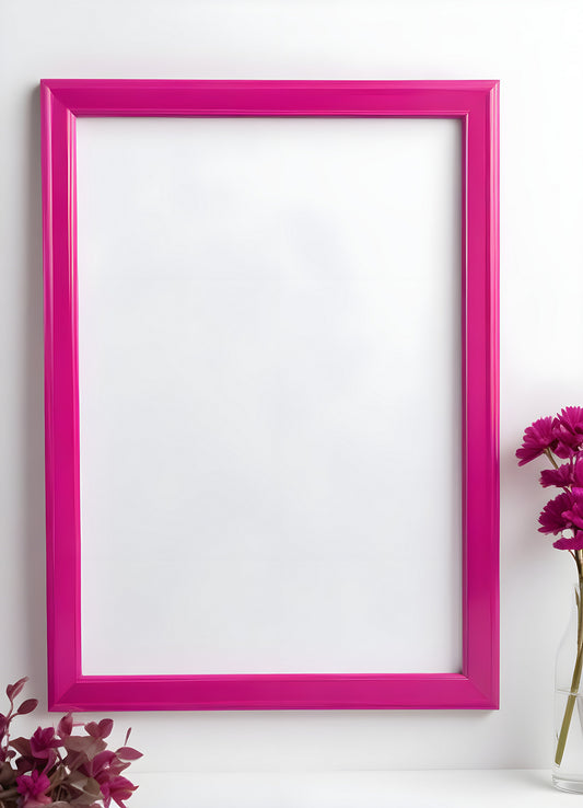 Bright pink empty frame stands against a white wall, inviting creativity and personal expression