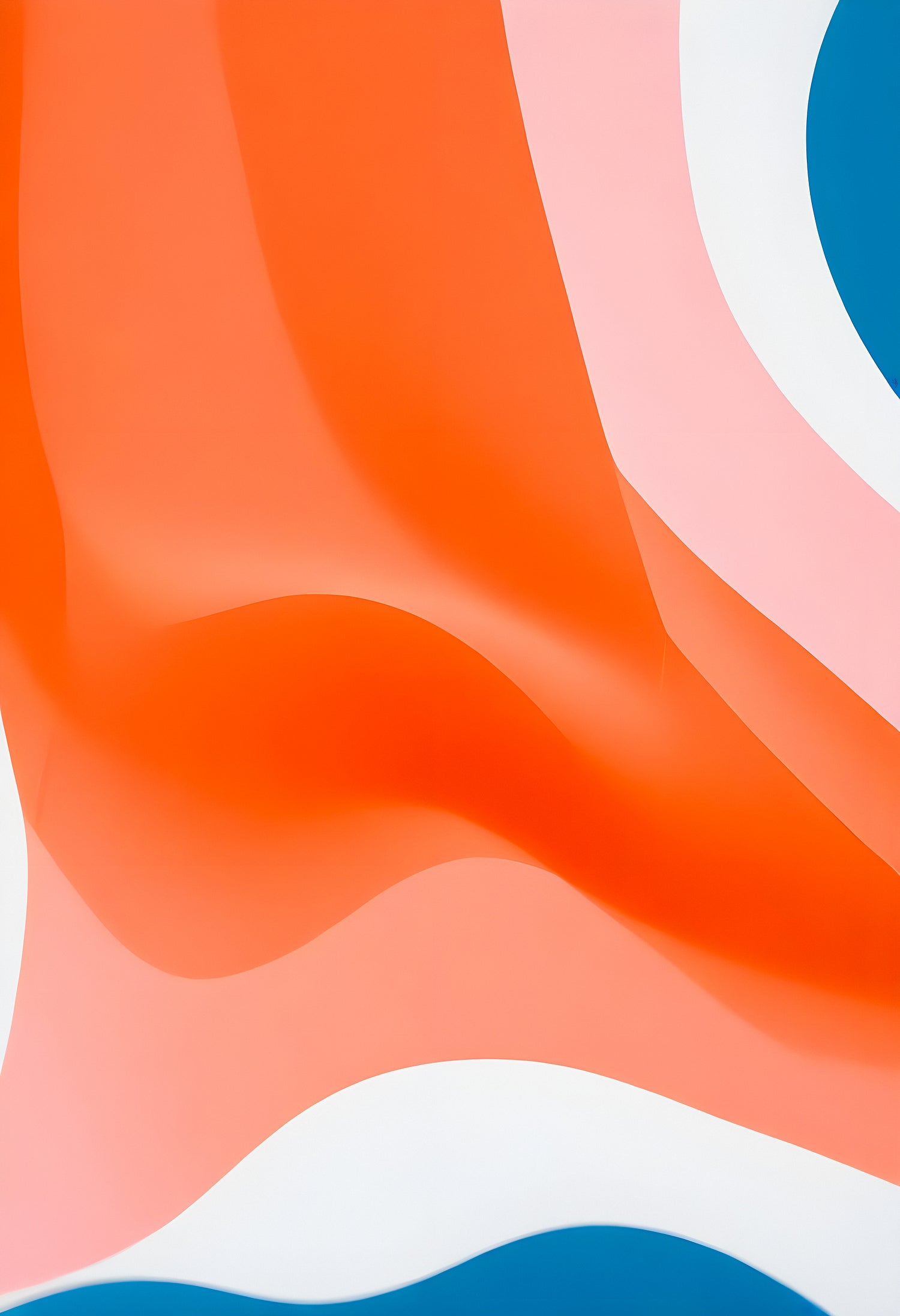 Colorful abstract waves of orange, pink, and blue fabric flowing together in a vibrant display