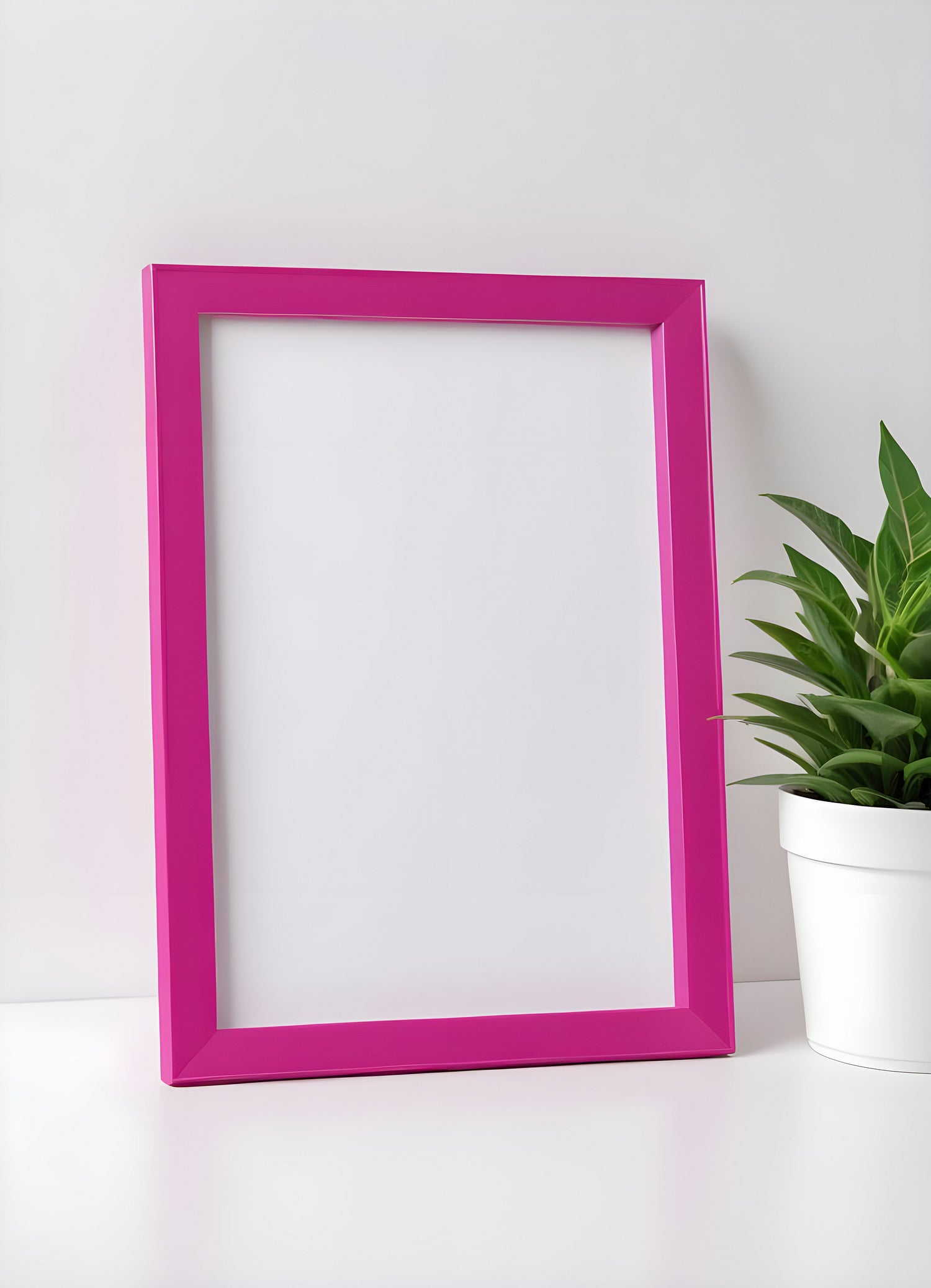 Bright pink empty frame stands against a white wall, inviting creativity and personal expression