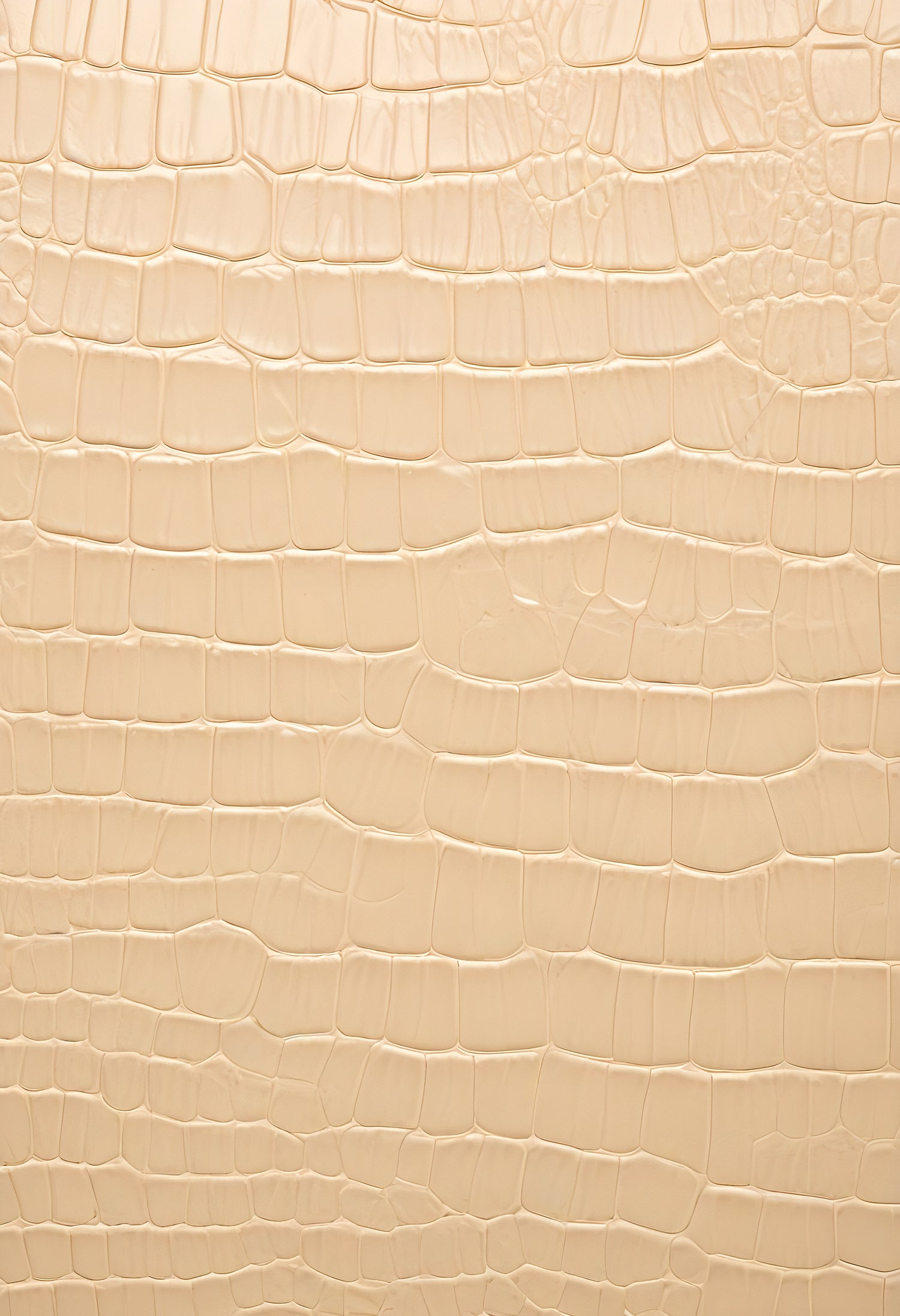 Textured beige alligator leather background showcasing unique patterns and details