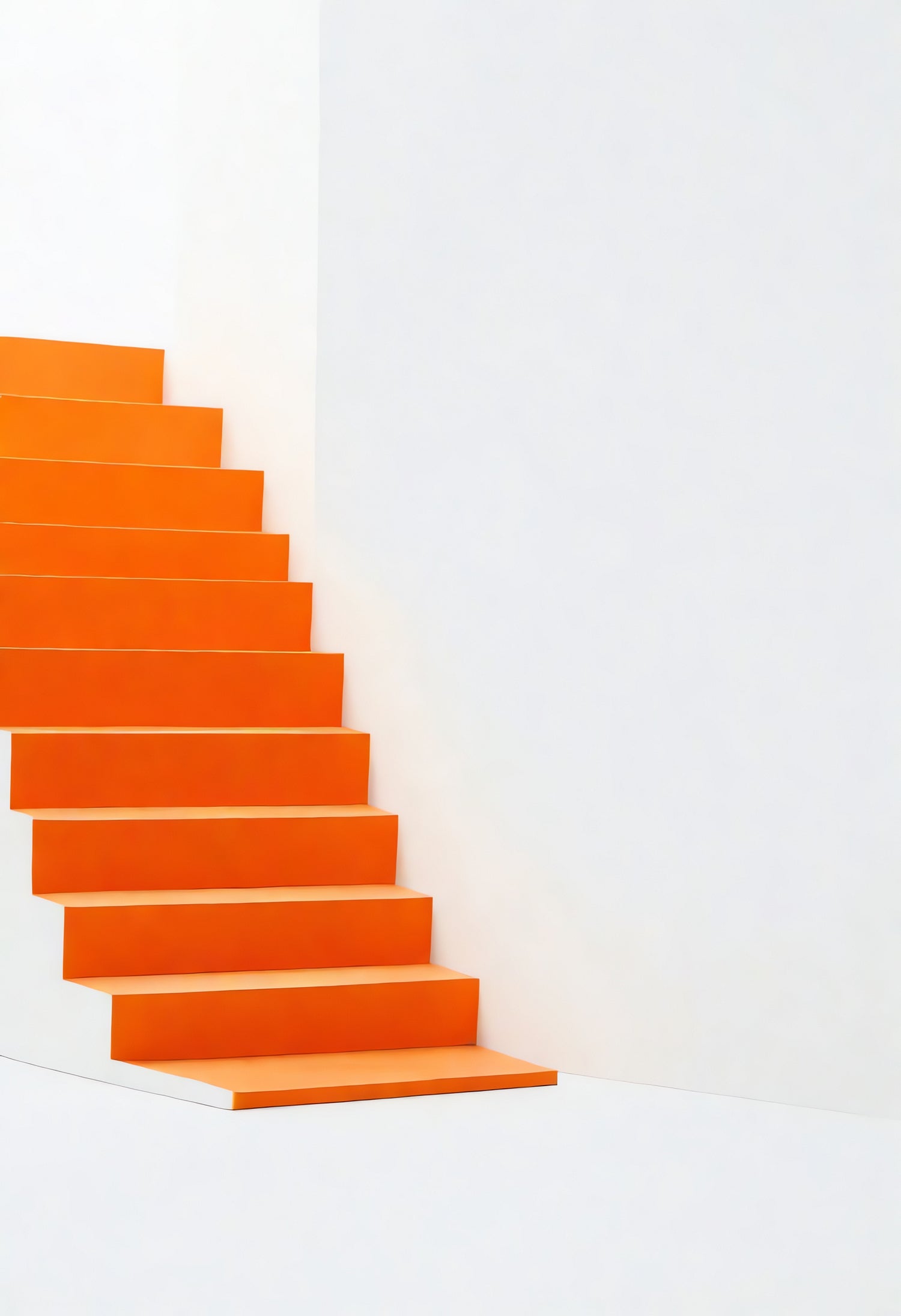 Bright orange staircase leading to a blank white wall in a modern interior space