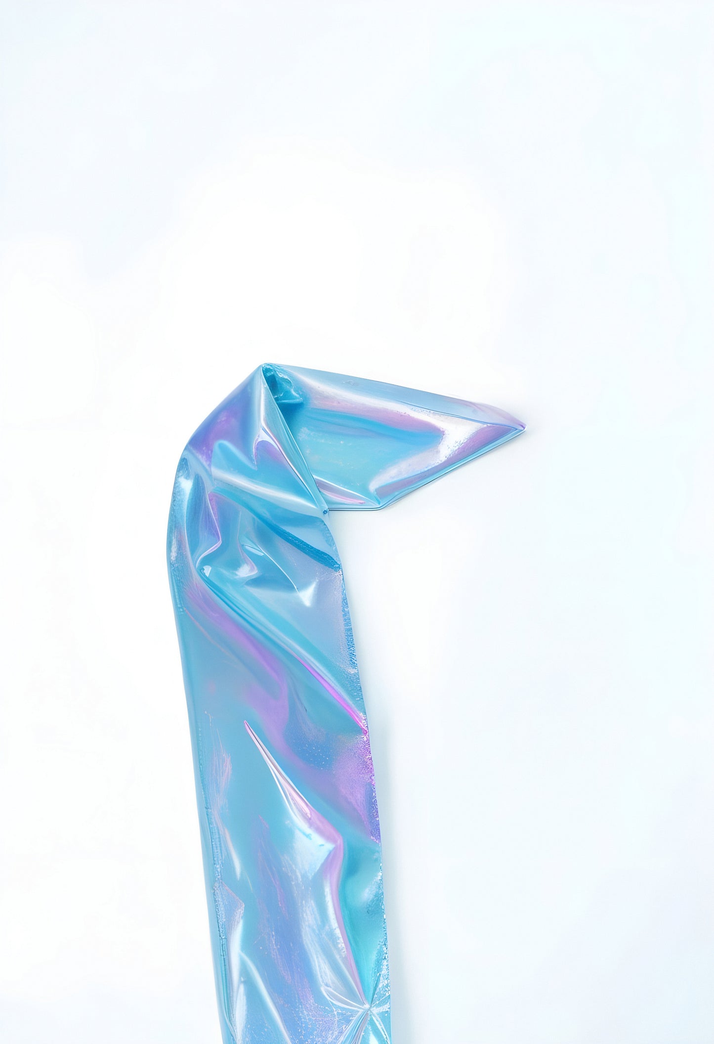 Shimmering blue iridescent ribbon draped elegantly on a light background in a creative workspace