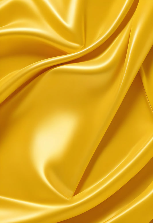 Shiny yellow satin fabric, perfectly draped and folded, creating waves and texture, suitable for costumes or elegant decor