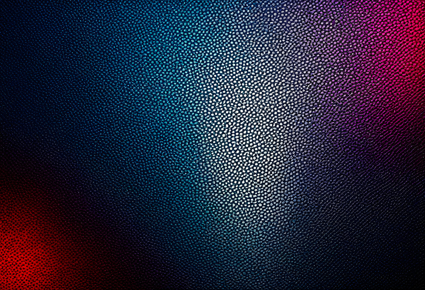 Textured surface with blue and purple tones illuminated by light