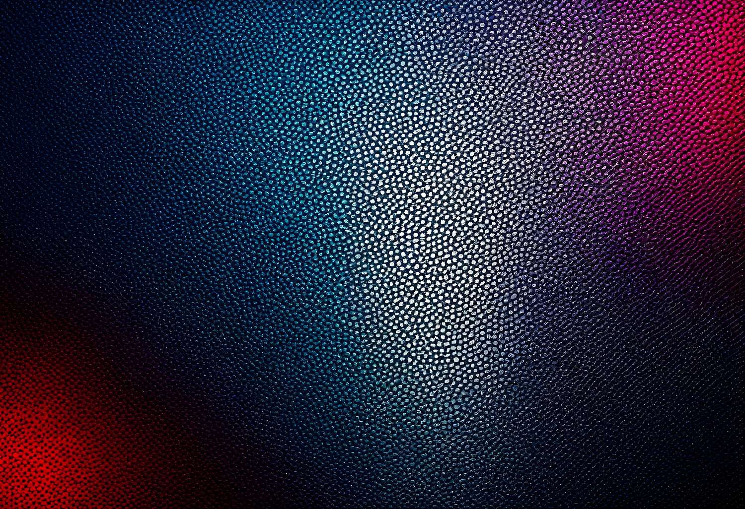 Textured surface with blue and purple tones illuminated by light