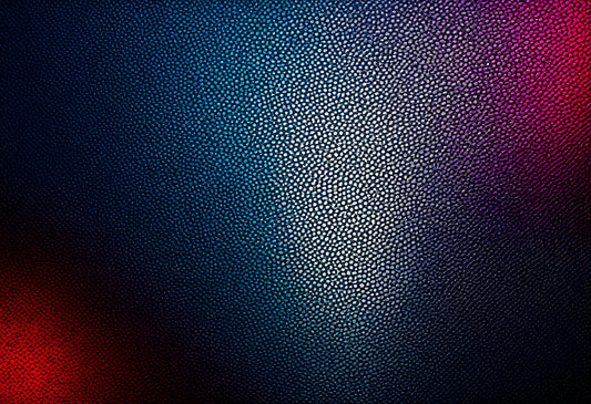 Textured surface with blue and purple tones illuminated by light