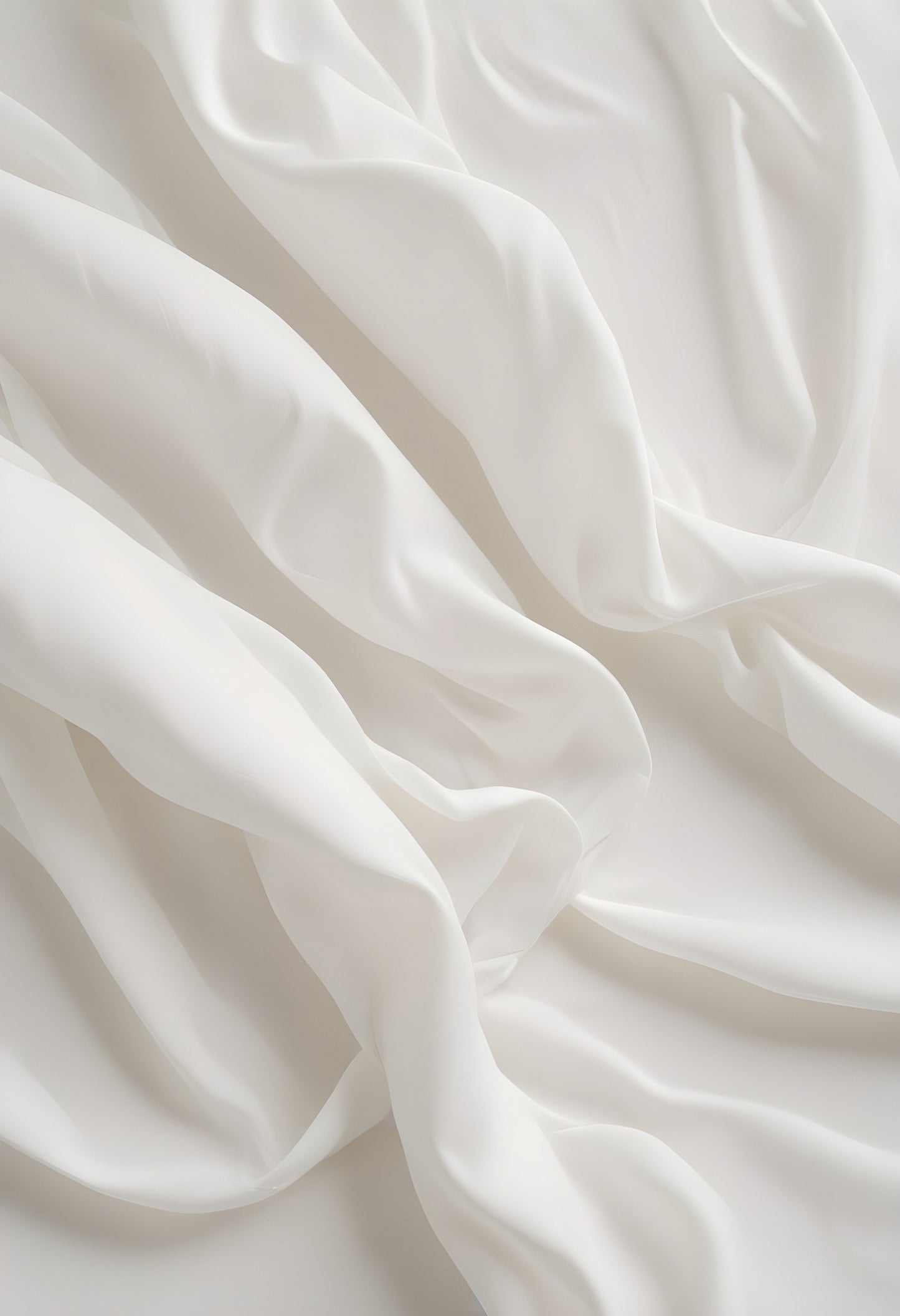 Soft white fabric draped elegantly on a flat surface creating a serene and tranquil aesthetic in natural light