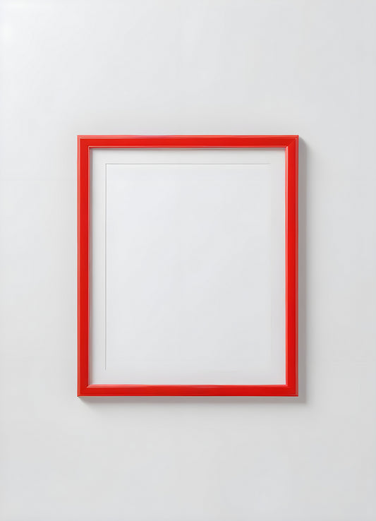 Empty red and white frame placed on a white shelf against a light gray wall, showcasing its modern design and simplicity