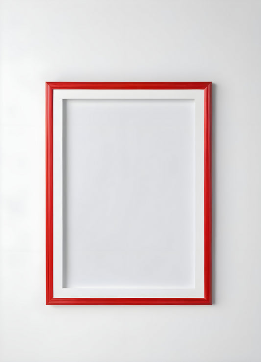 Empty red and white frame placed on a white shelf against a light gray wall, showcasing its modern design and simplicity