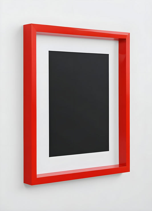 A bright red frame on a plain white wall, perfect for displaying artwork or photographs in a modern interior setting