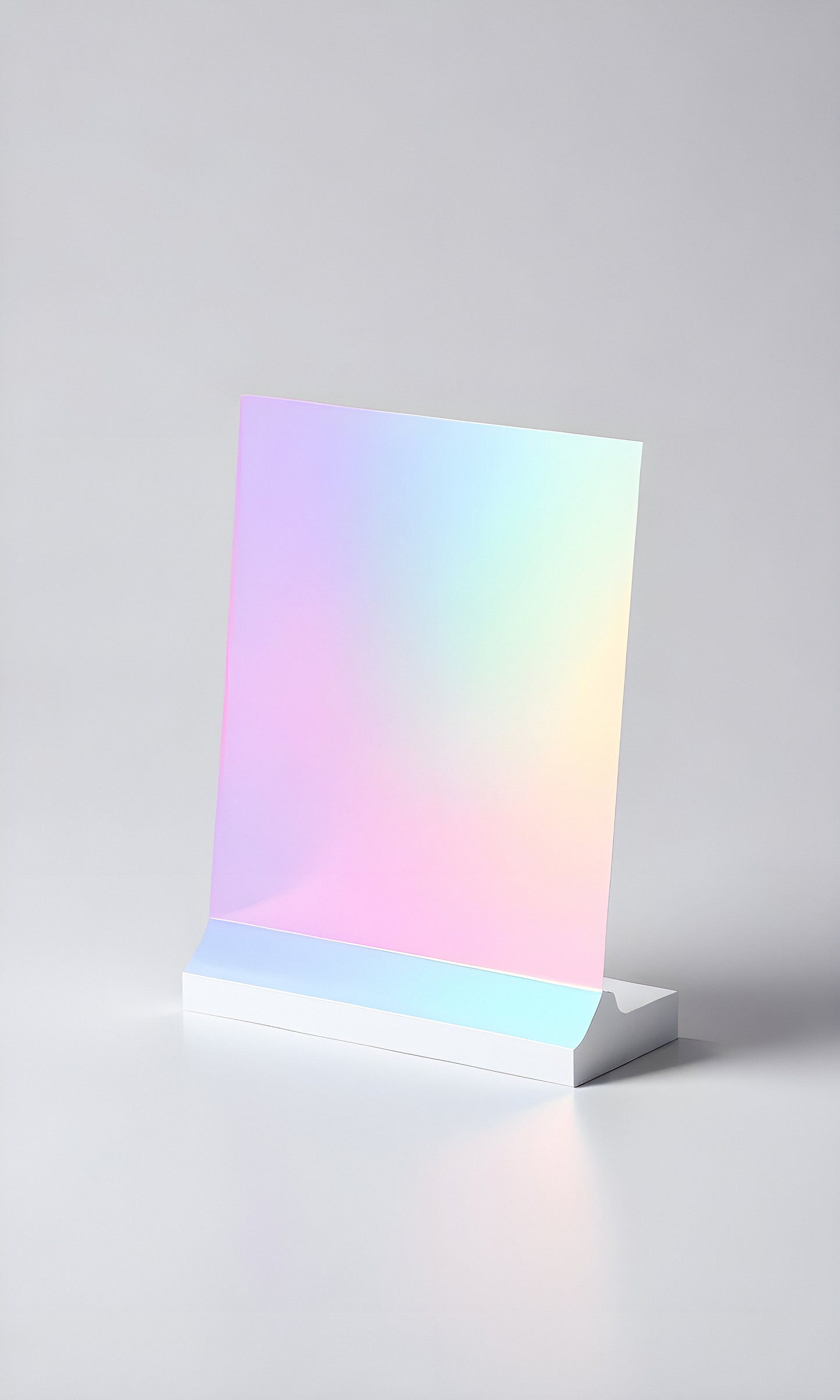 A sleek holographic sheet displayed on a simple white stand against a minimalist background in bright light