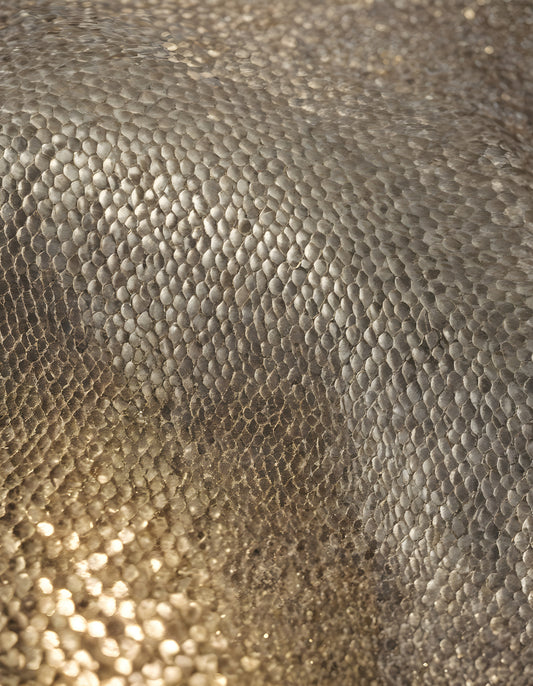 Sparkling golden fabric draping gracefully under soft light during a creative textile project