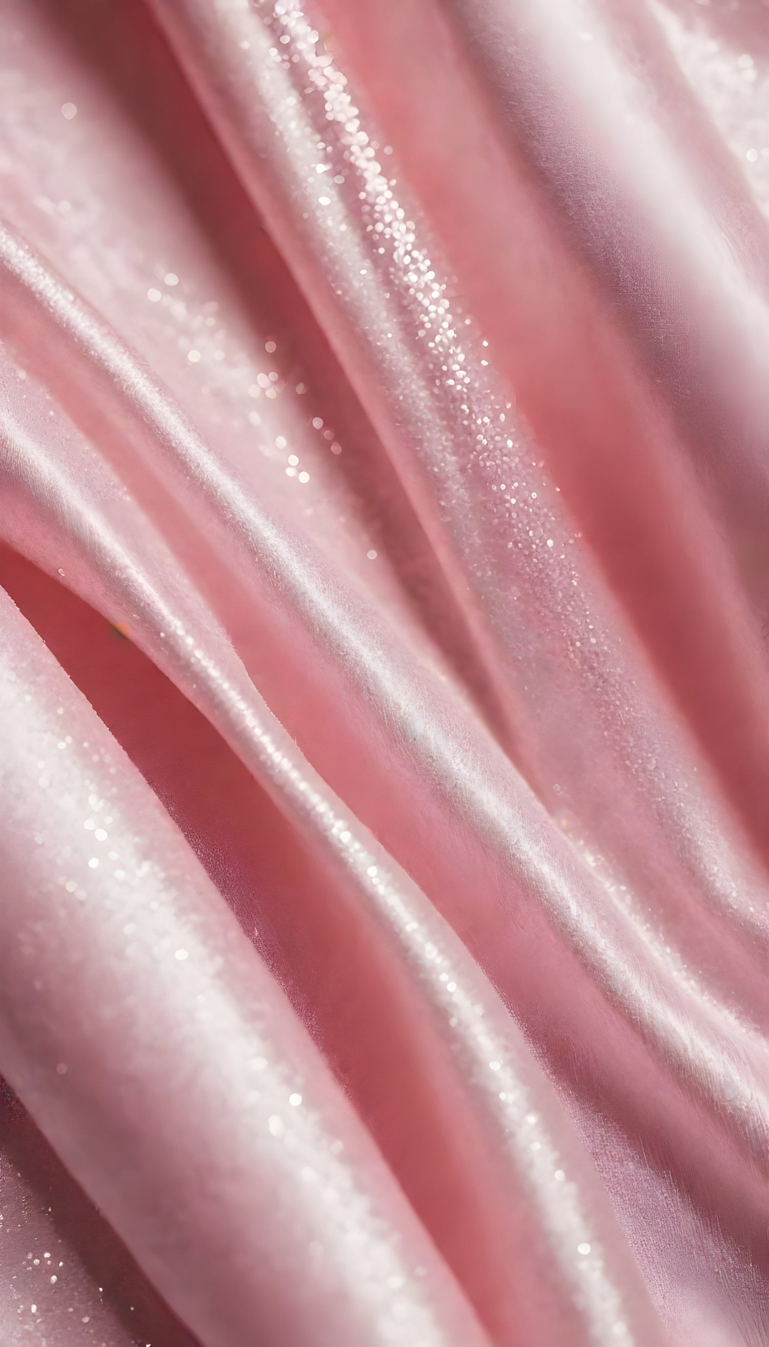 A close-up view of soft, shiny pink fabric draped elegantly, highlighting its smooth texture and sheen, perfect for luxurious designs