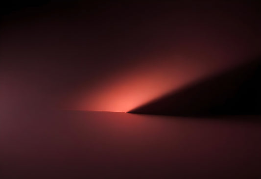 Soft gradient light casting shadows on a smooth surface during twilight in a minimalist setting