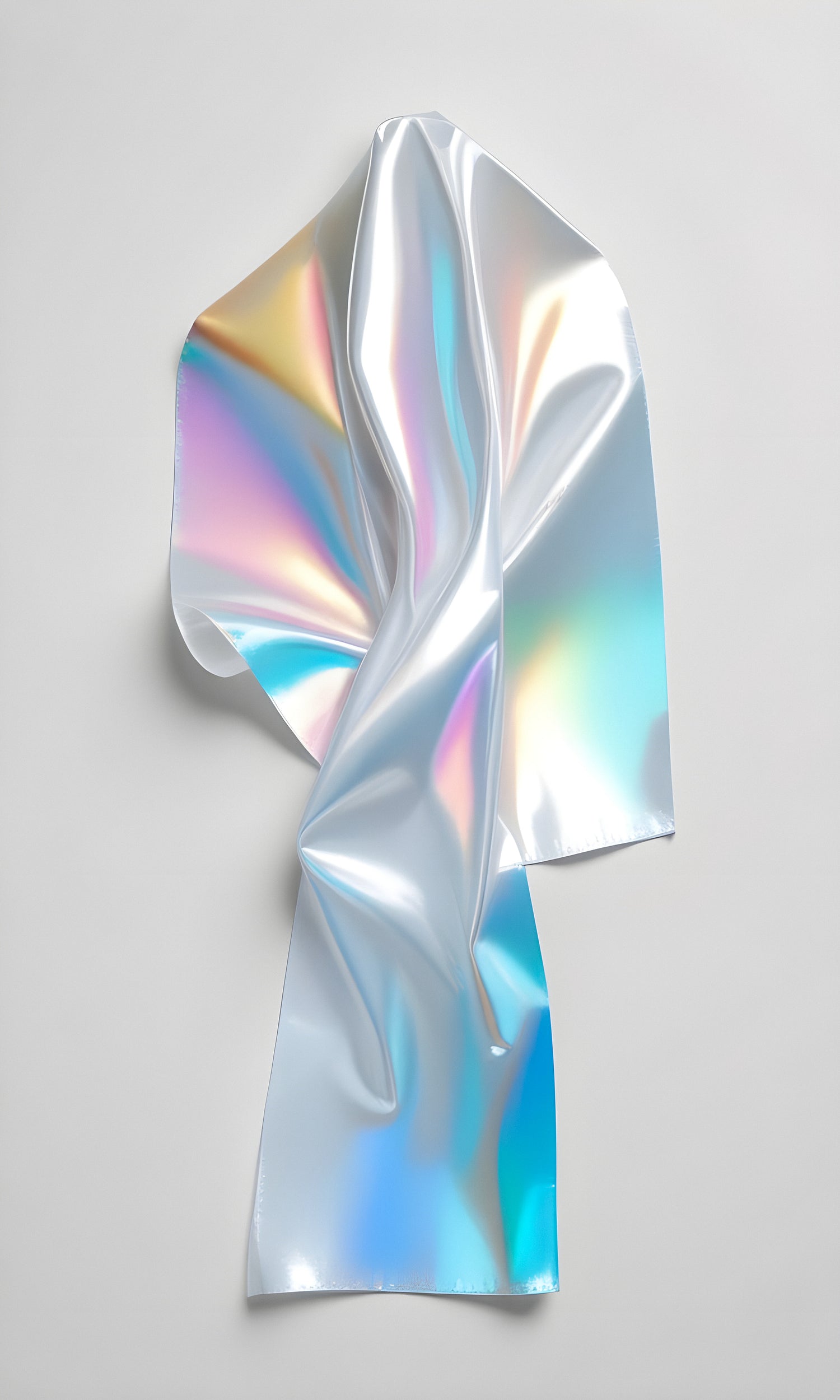 A vibrant, crumpled sheet of holographic material creating a colorful reflection on a neutral background