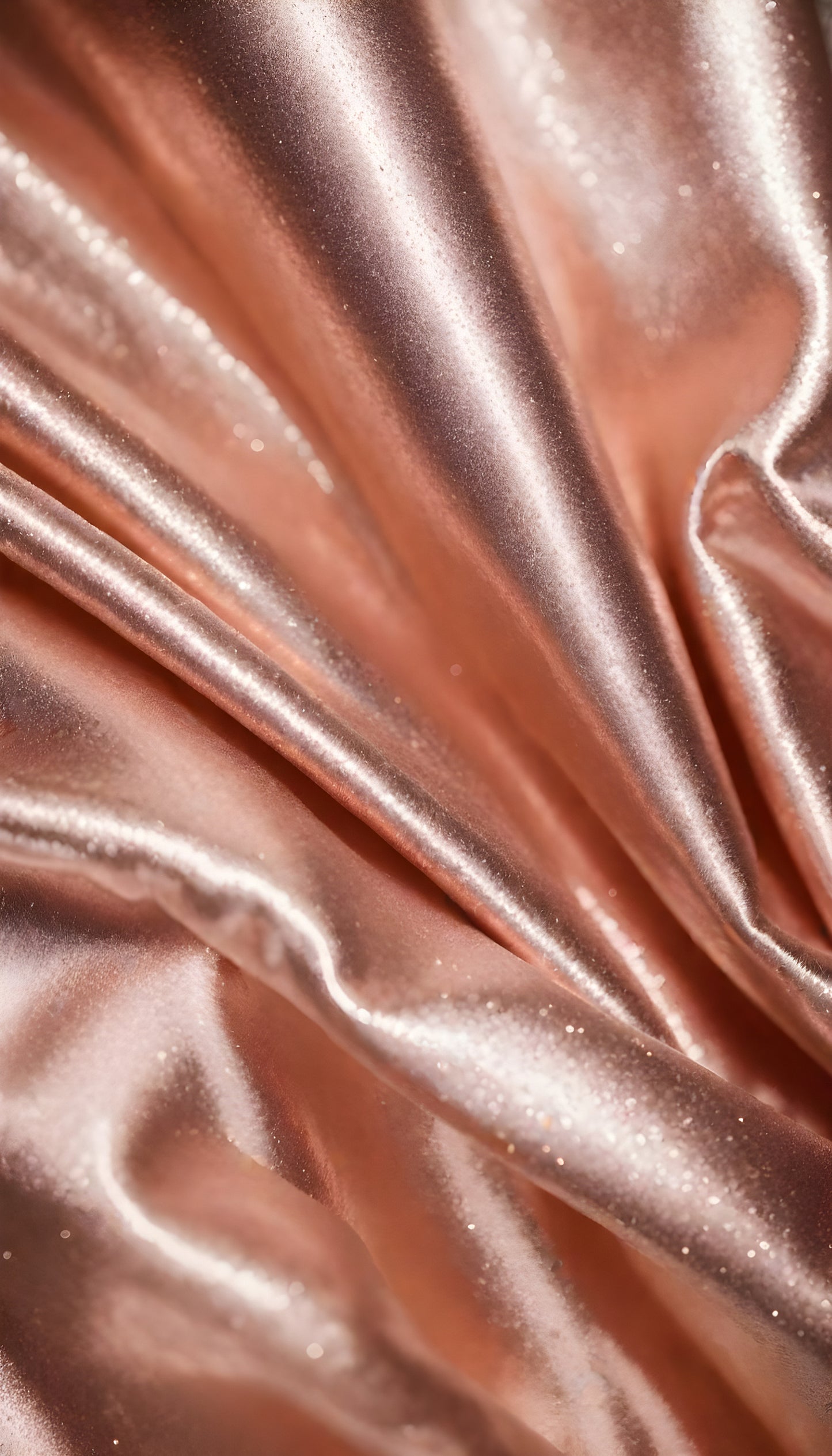 Shimmering rose gold fabric draping elegantly with soft folds under bright light in a studio setting