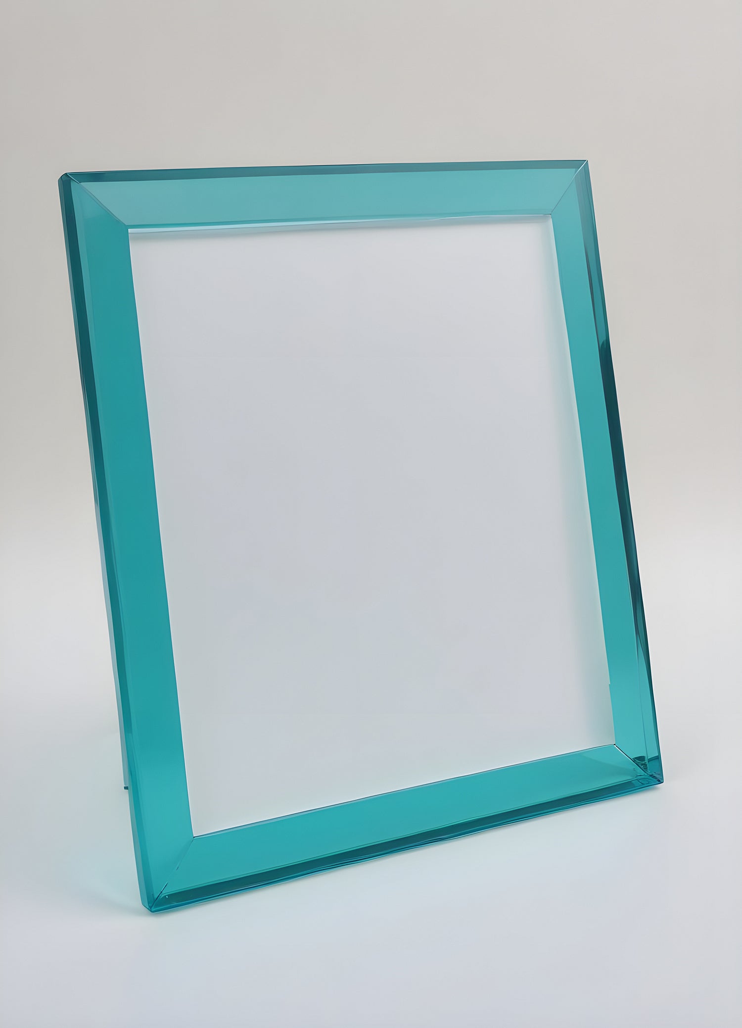 Empty teal picture frame with a minimalist design positioned softly against a light background