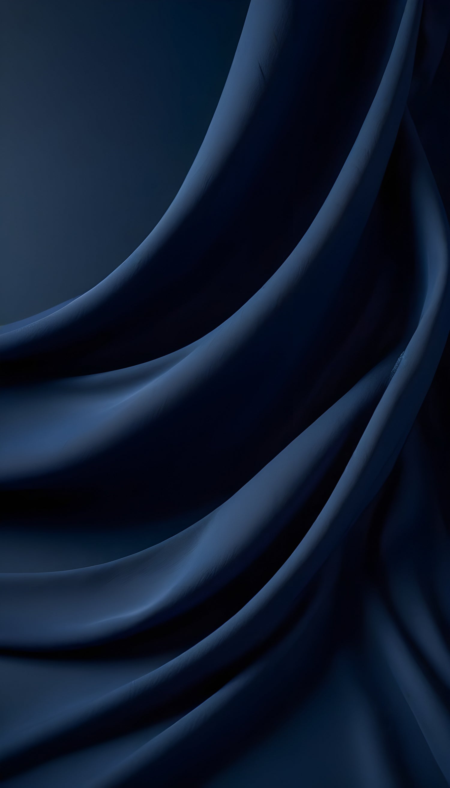 Elegant dark blue fabric draped gracefully, showcasing smooth textures and soft folds in ambient lighting