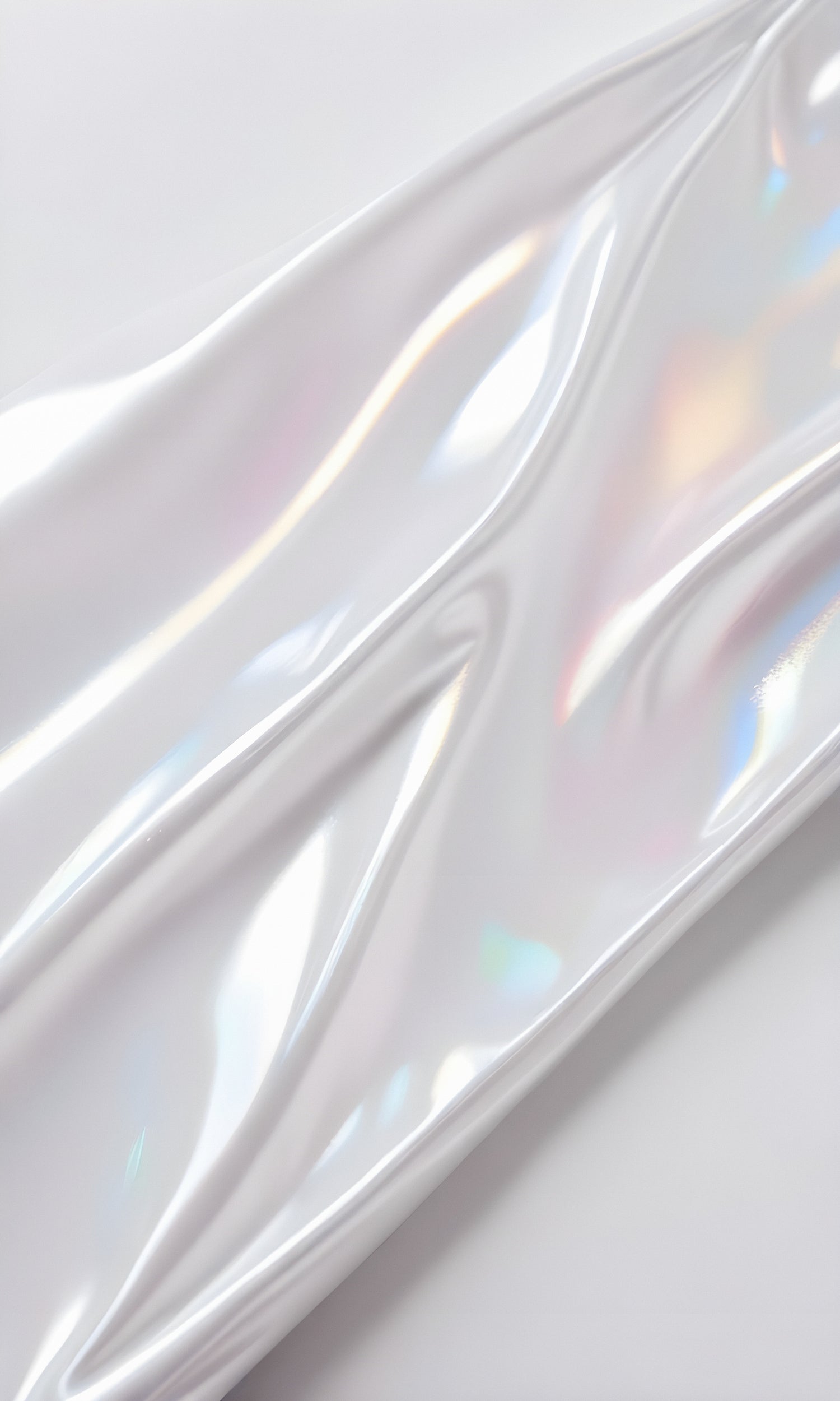 Glossy white material with iridescent patterns on a smooth surface in bright lighting