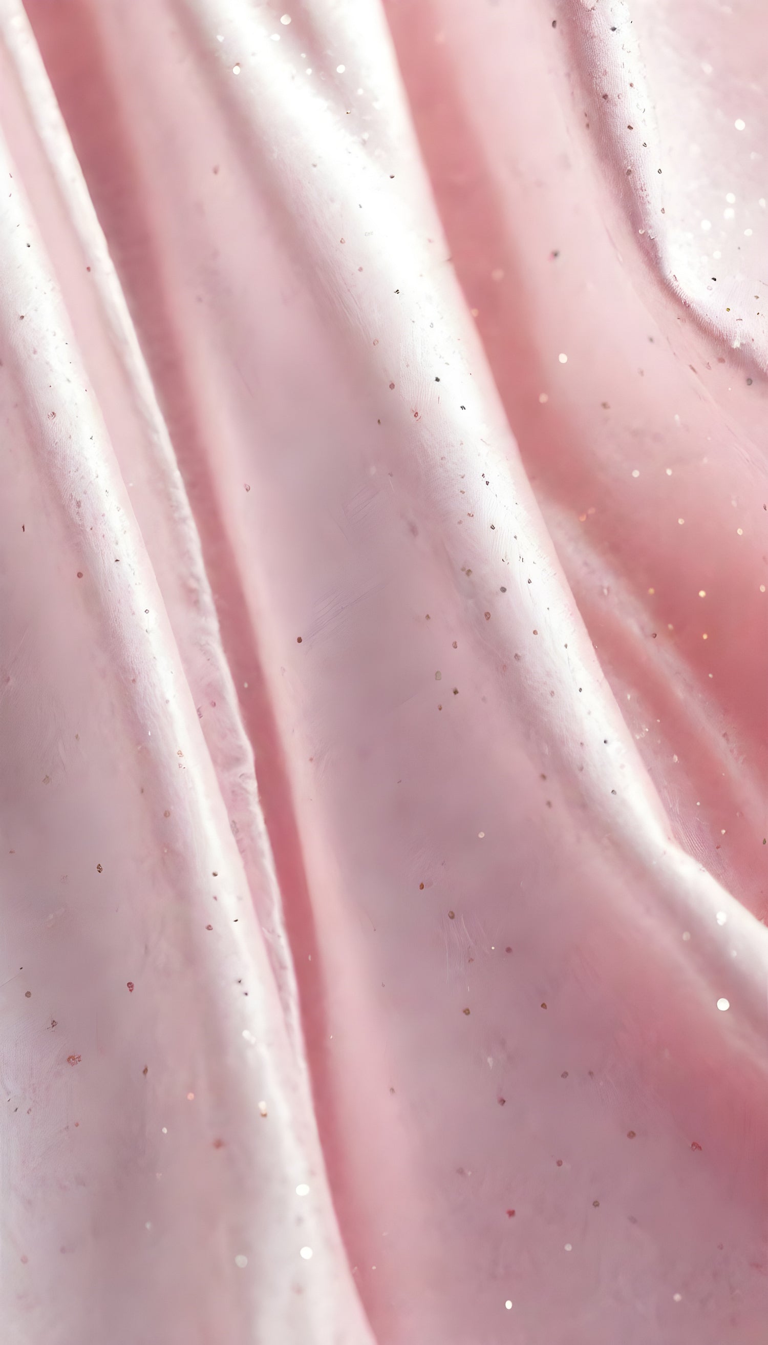 A close-up view of soft, shiny pink fabric draped elegantly, highlighting its smooth texture and sheen, perfect for luxurious designs