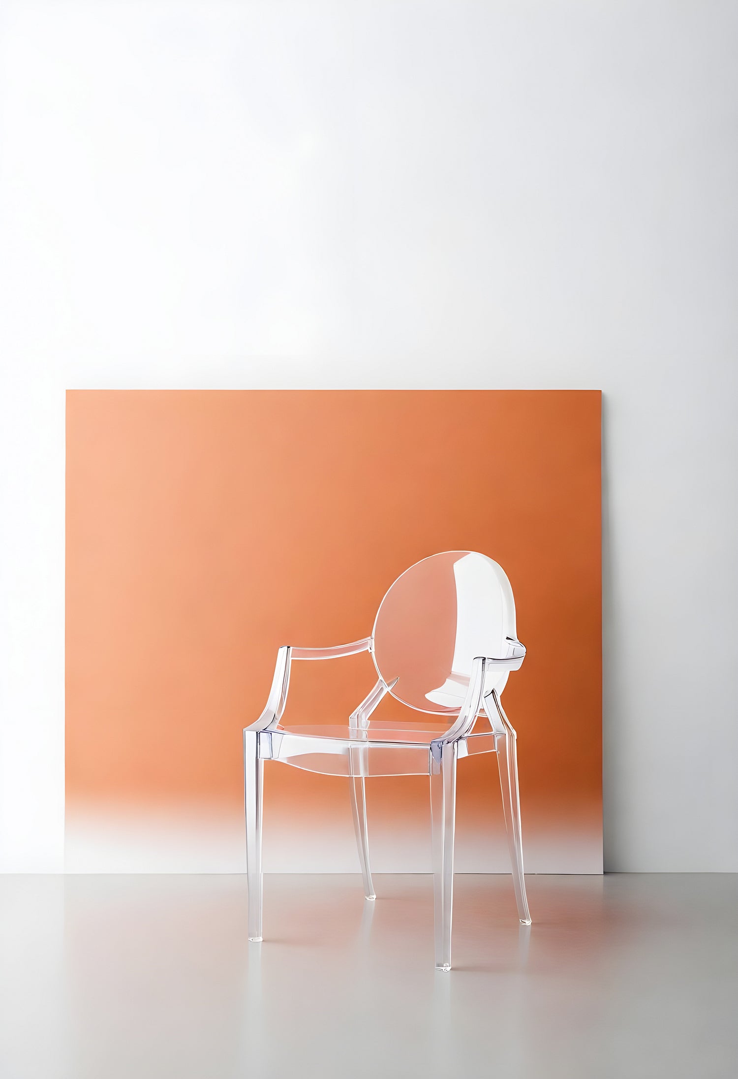 Clear acrylic chair positioned against a vibrant orange backdrop in a minimalist interior setting during daylight