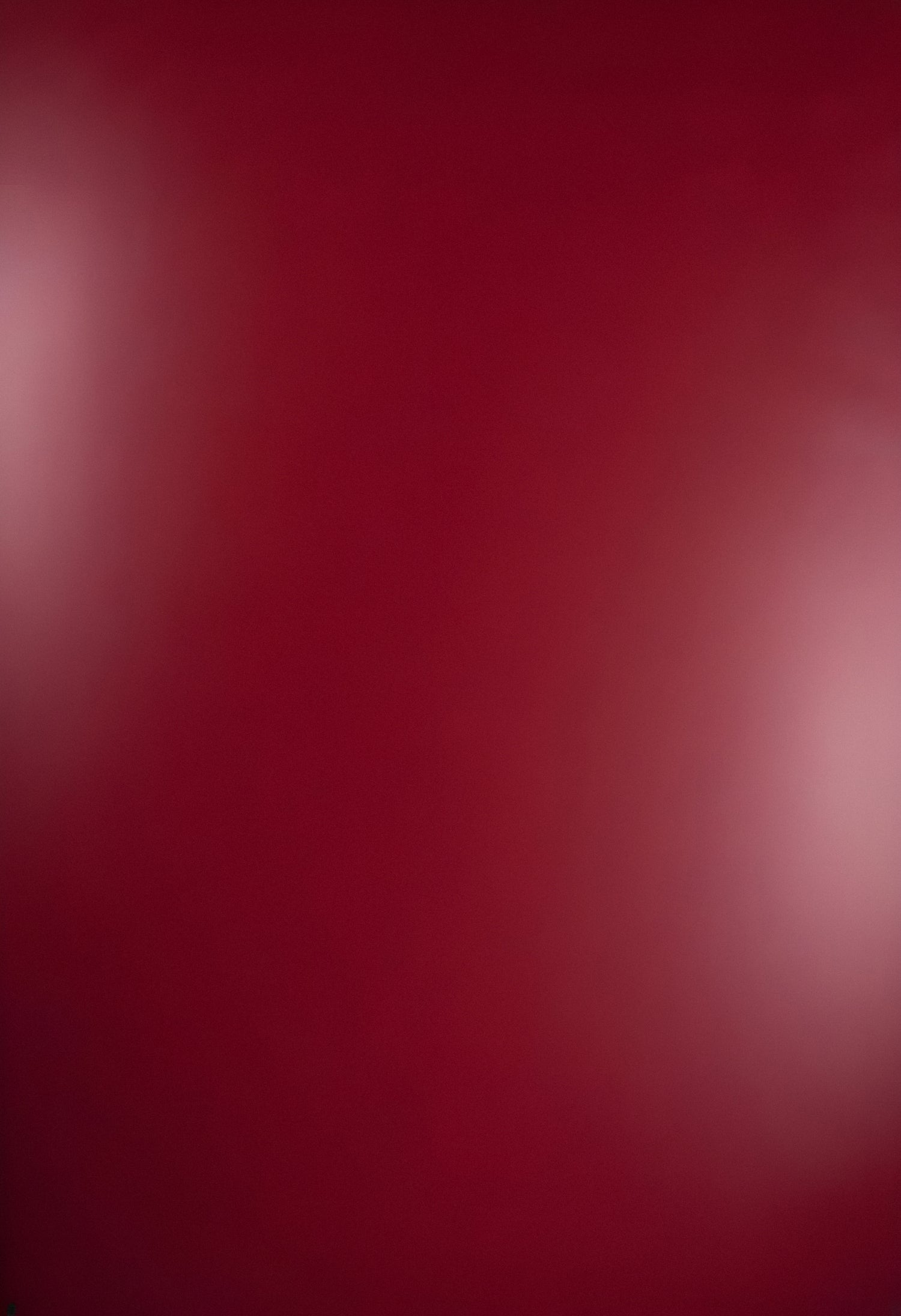 Abstract red background with subtle gradient and soft highlights