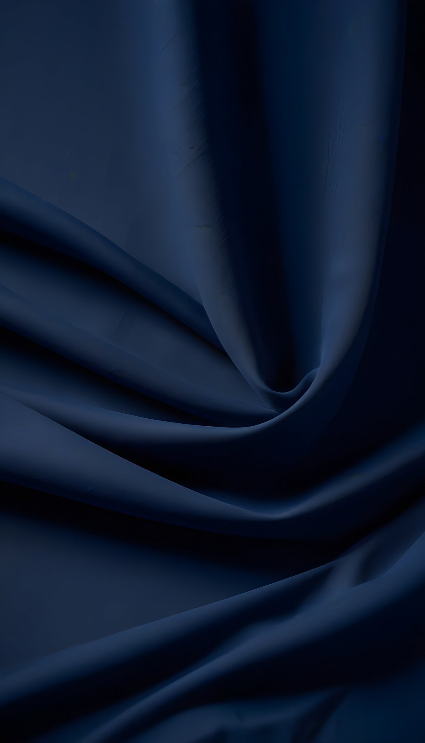 Elegant dark blue satin fabric with smooth drapes and soft textures captured in natural light