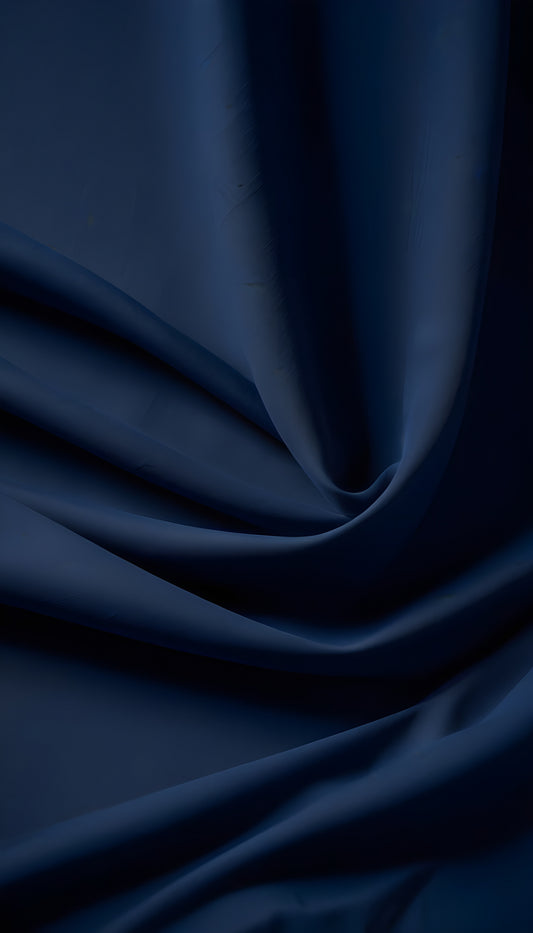 Elegant dark blue satin fabric with smooth drapes and soft textures captured in natural light