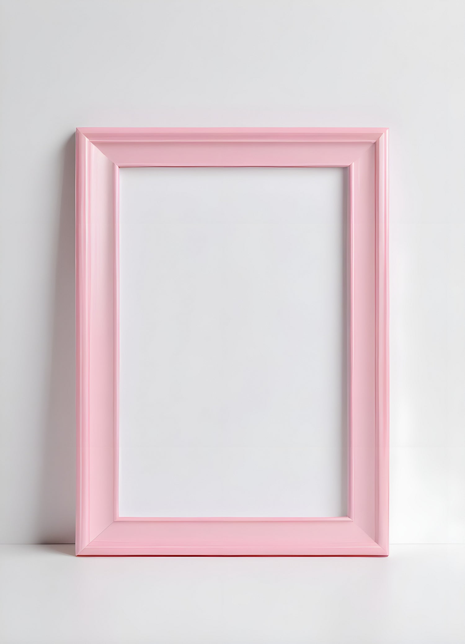 A simple pink frame resting against a white wall, suitable for displaying artwork or photographs in a bright interior setting