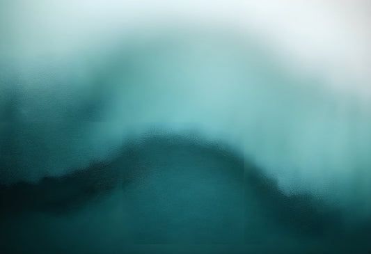 Abstract blurred ocean wave in shades of blue and green during calm weather in a tranquil setting