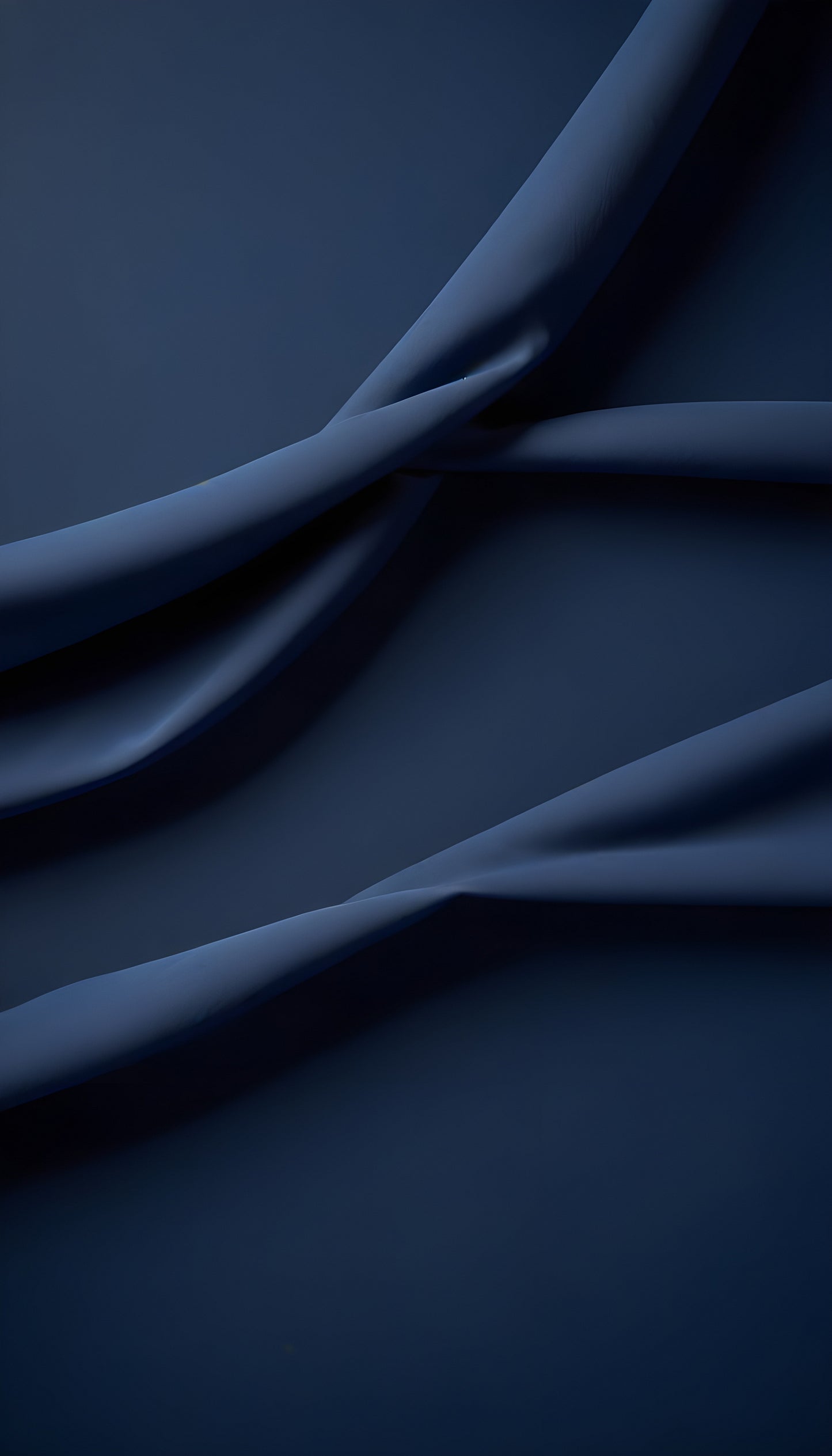 Elegant dark blue fabric drapes beautifully on a smooth surface, showcasing its texture and flowing lines