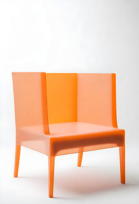 Bright orange transparent chair in modern minimalistic style against a plain white background