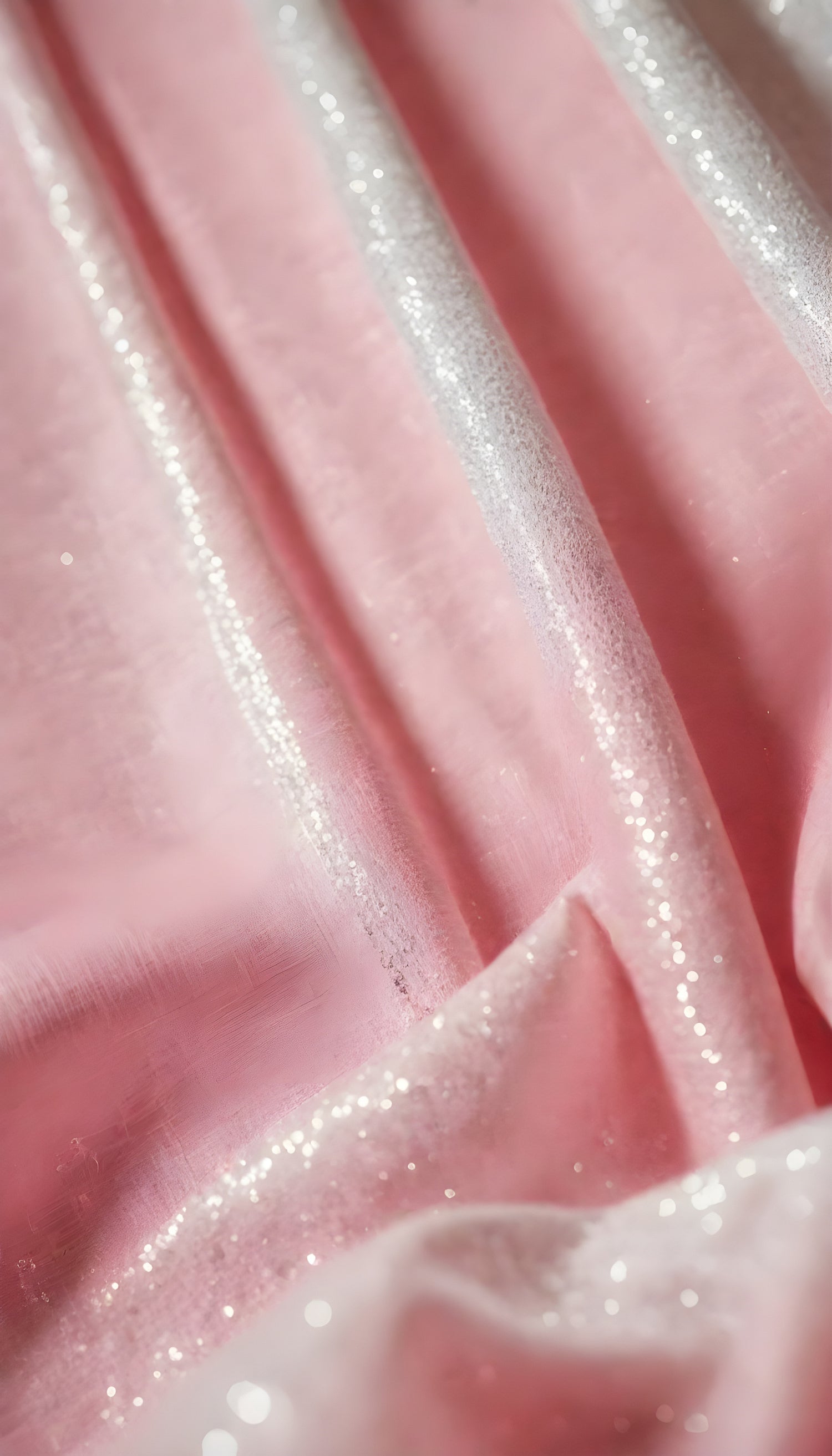 A close-up view of soft, shiny pink fabric draped elegantly, highlighting its smooth texture and sheen, perfect for luxurious designs