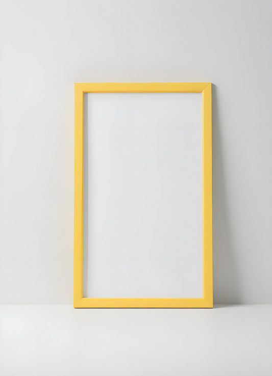 A bright yellow frame and minimalist vase with decorative grass placed on a white shelf in a modern interior setting